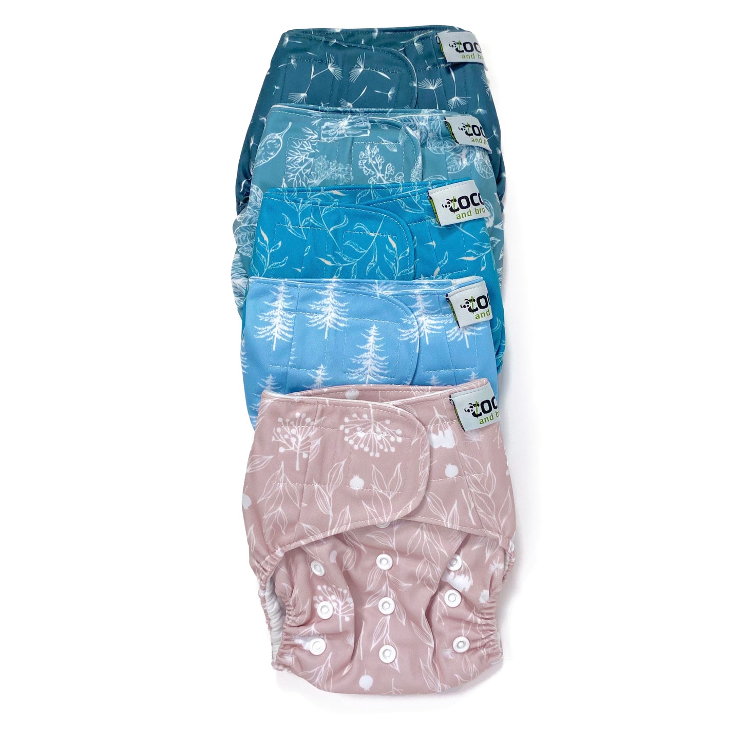 A set of five reusable nappies, made from 100% recycled polyester. The included nappies are: Wild Lilac, Cool Pines, Blue Fern, Blue Harvest and Midnight Breeze. View shows all five nappies front facing, in a vertical line.