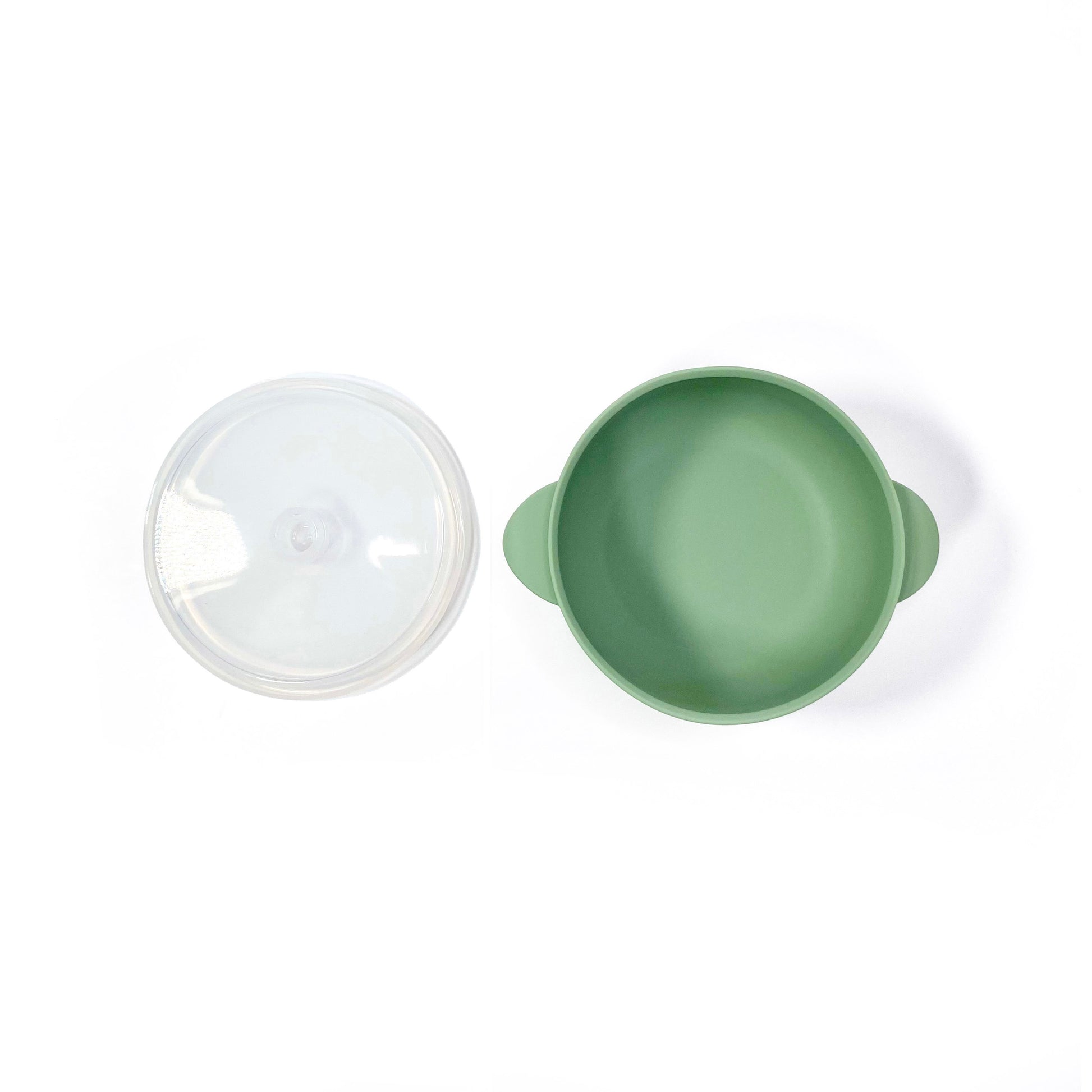A forest green silicone children’s feeding bowl, with lid and suction cup. Image shows the bowl with lid separately.