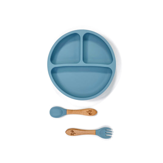 An ocean blue silicone children’s section plate with cups on the base, and matching bamboo and silicone cutlery.