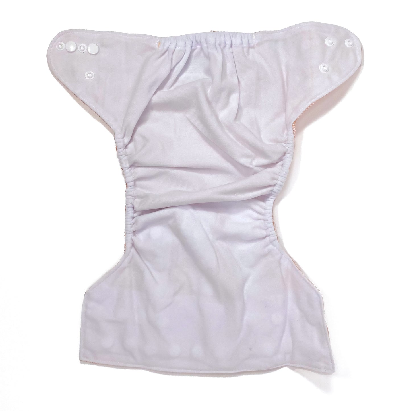 An adjustable reusable nappy for babies and toddlers, featuring a peach rainbow design, with images of white rainbows on a peach background. View shows the inside fabric of the nappy.