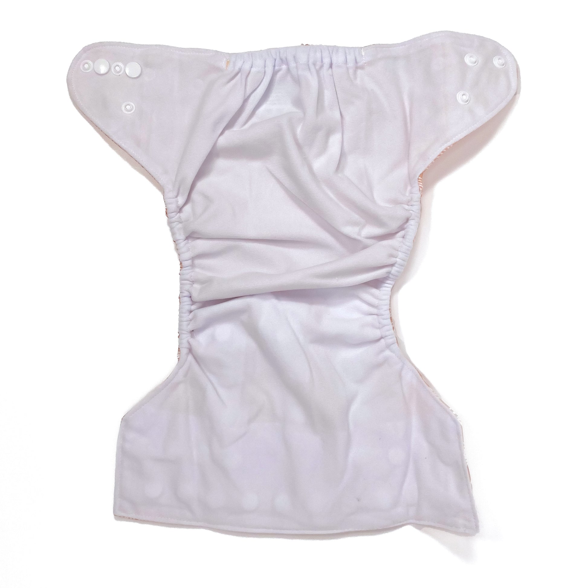 An adjustable reusable nappy for babies and toddlers, featuring a peach rainbow design, with images of white rainbows on a peach background. View shows the inside fabric of the nappy.