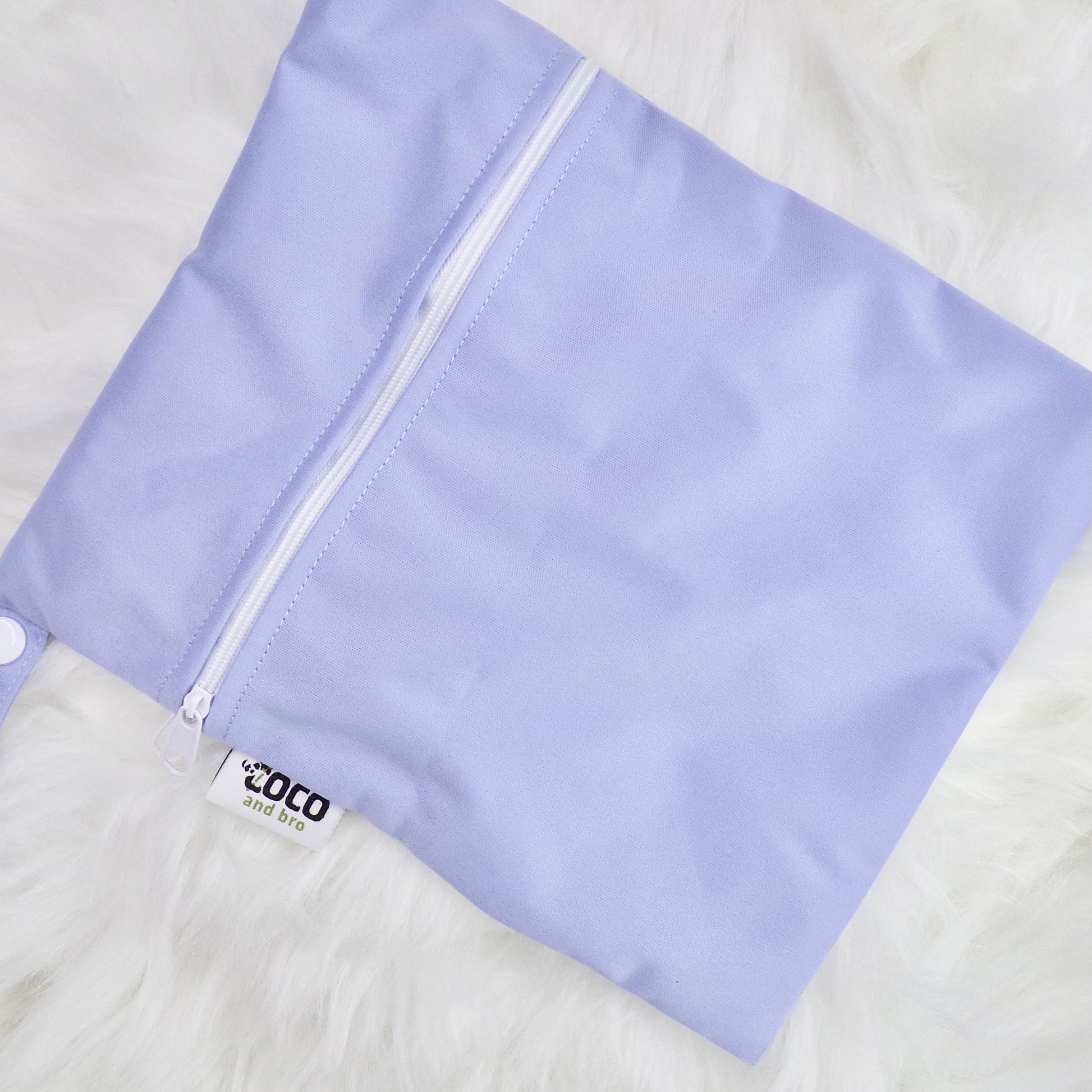 This image shows a waterproof bag in purple, with a zip closure.