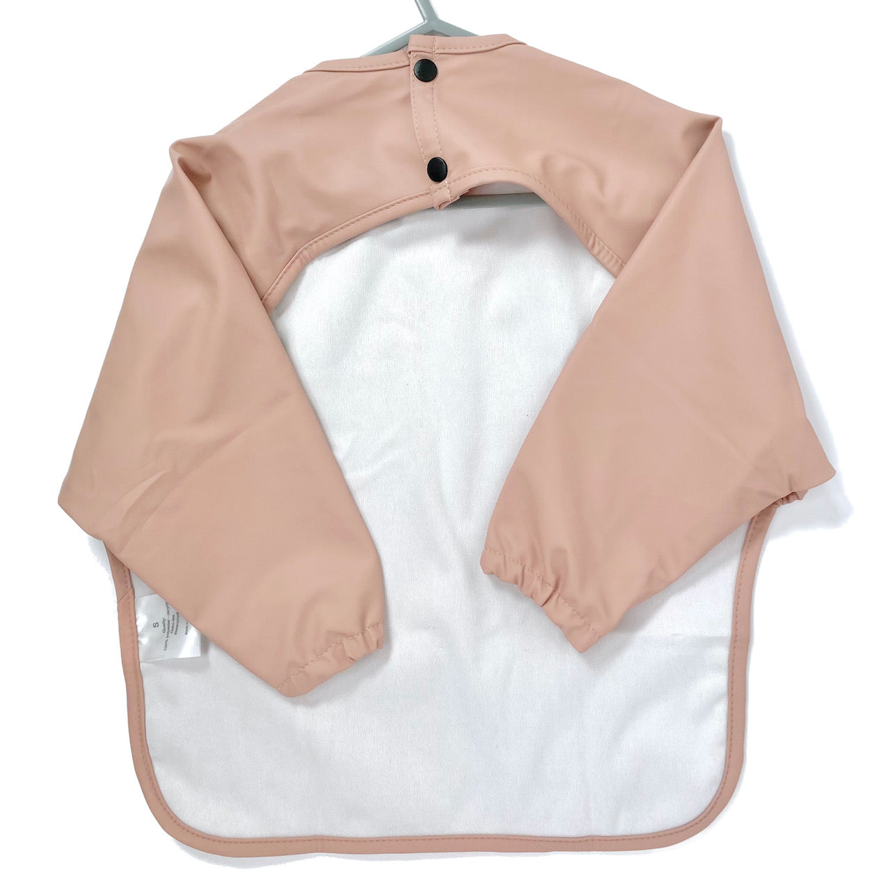 Long-sleeve kids apron in rose pink colour, showing back view.