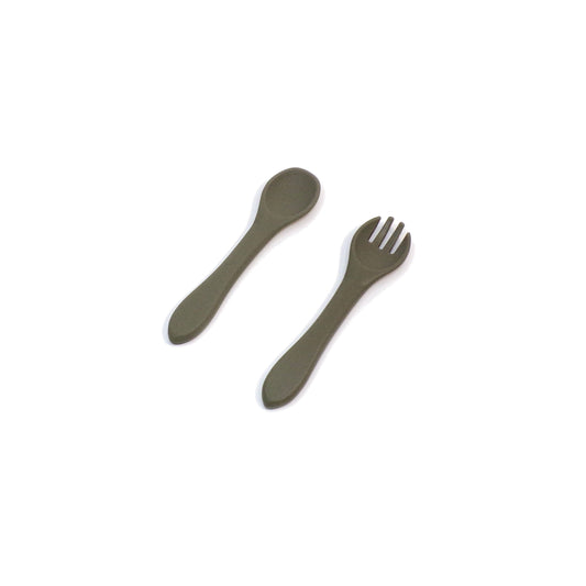 A set of green silicone cutlery, a fork and spoon, designed for young children.