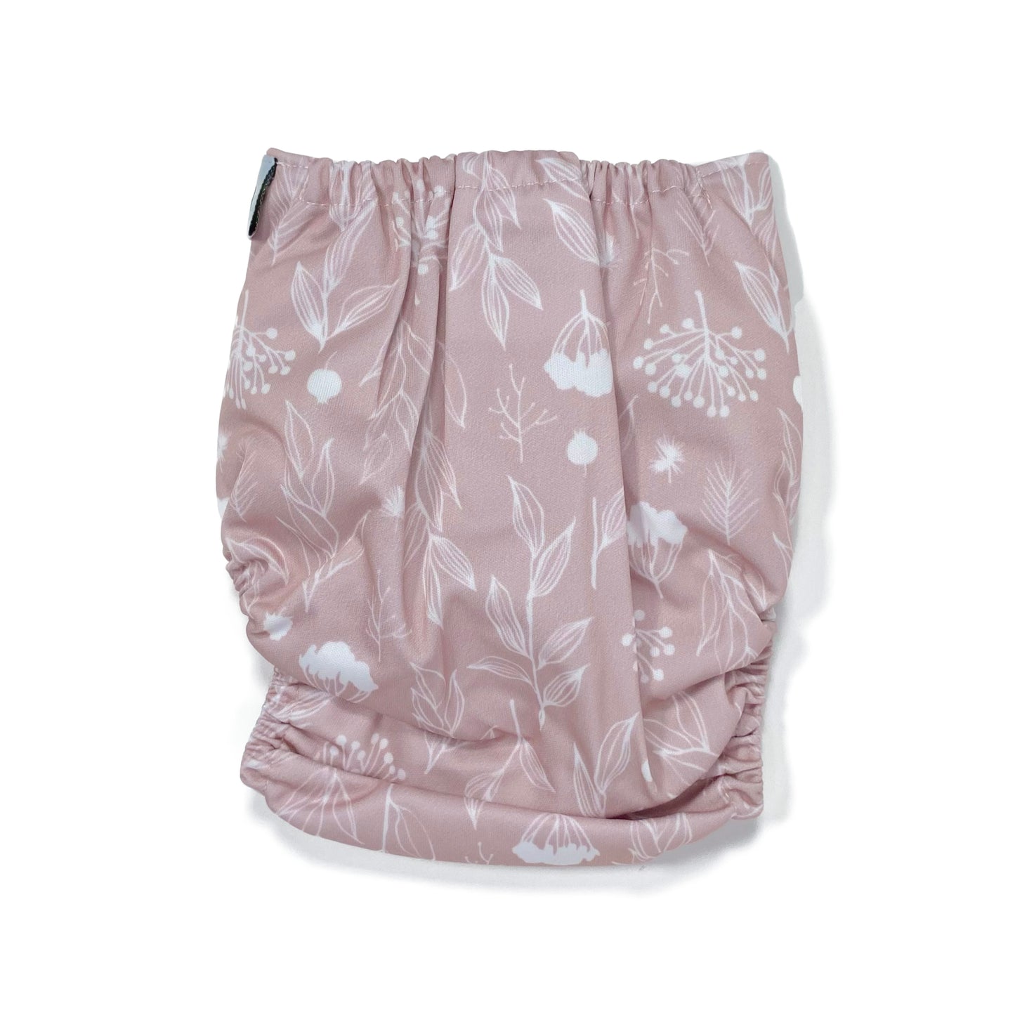 An adjustable reusable nappy for babies and toddlers, featuring a floral lilac design, with floral images on a lilac background. View shows the back of the nappy.