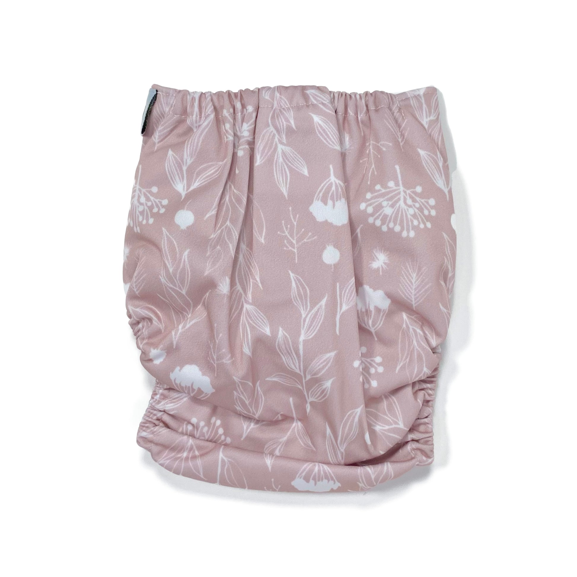An adjustable reusable nappy for babies and toddlers, featuring a floral lilac design, with floral images on a lilac background. View shows the back of the nappy.