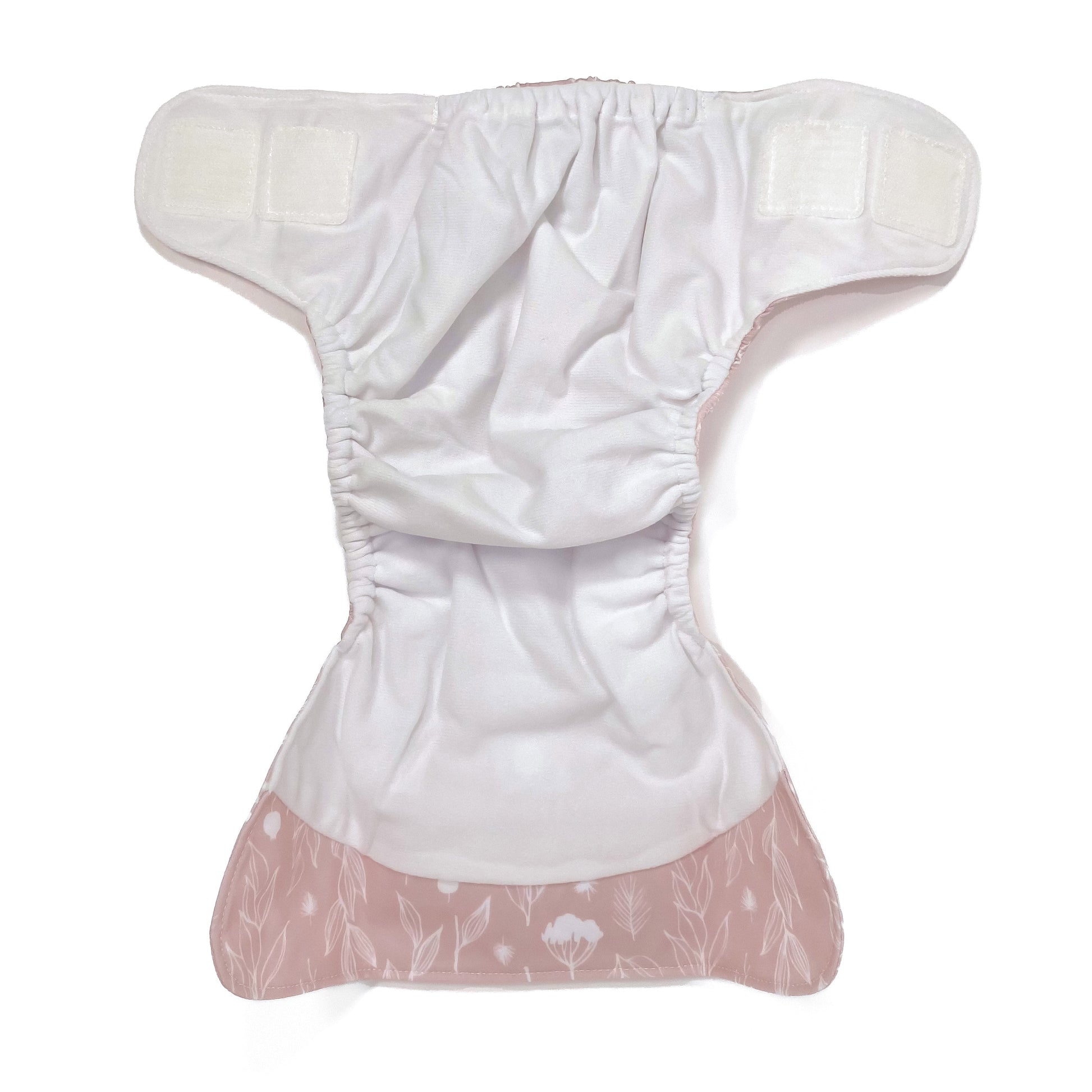 An adjustable reusable nappy for babies and toddlers, featuring a floral lilac design, with floral images on a lilac background. View shows the inside fabric of the nappy.