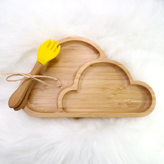 A children's bamboo section plate with a cloud design, yellow colour silicone suction ring and matching yellow bamboo and silicone cutlery. Front view.