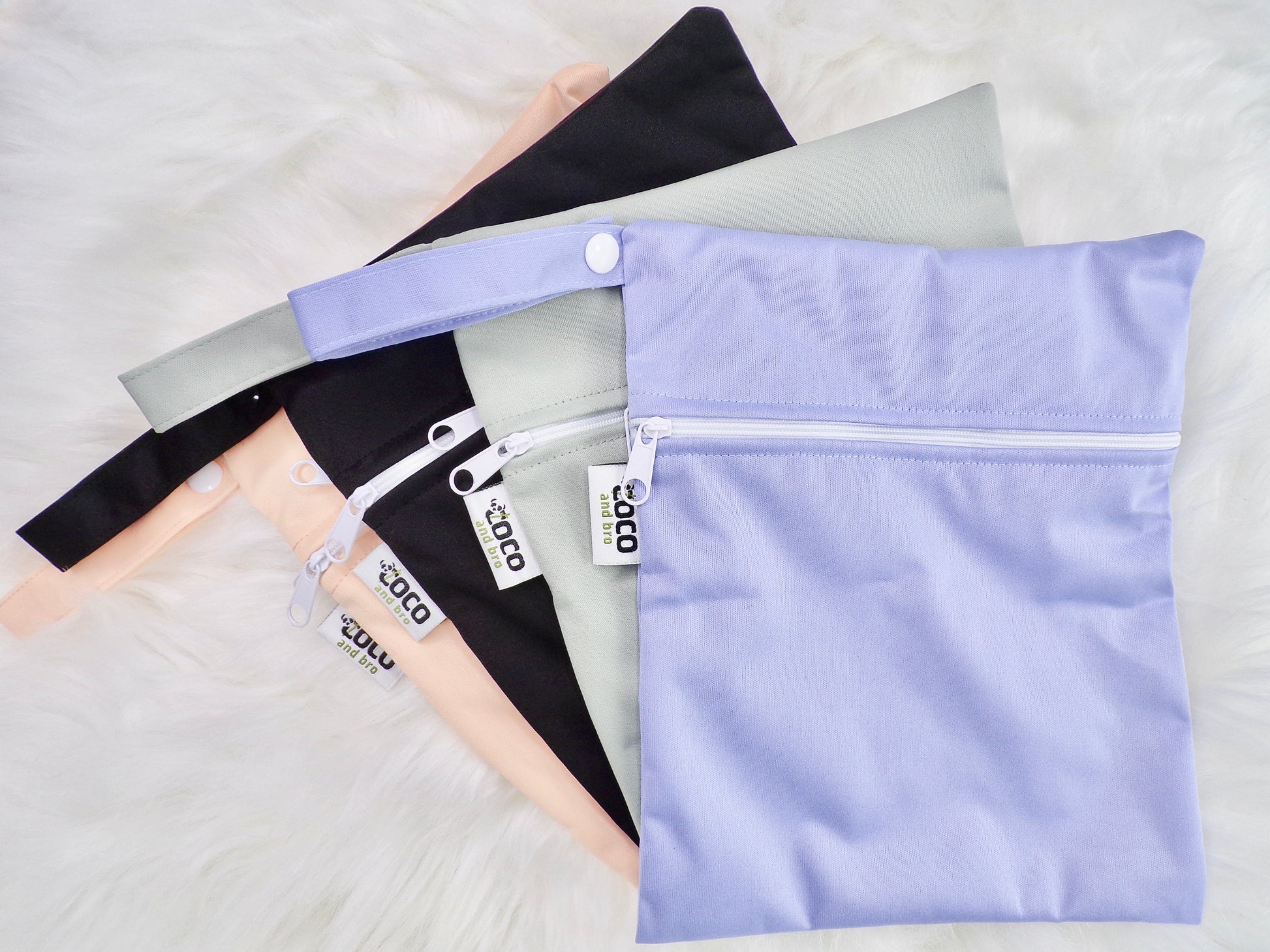A selection of waterproof bags. The bags are made from bamboo, and are available in black, grey, purple and peachy pink.