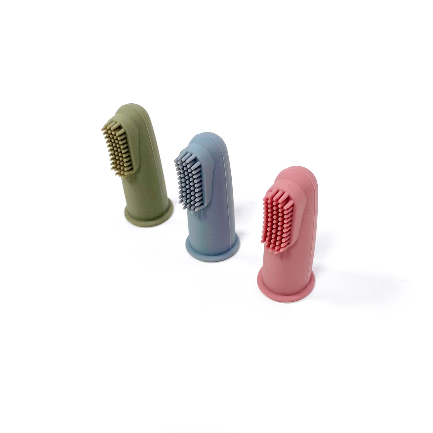 A set of silicone baby toothbrushes in colours khaki green, rose pink and ocean blue. Image shows the toothbrushes standing up, in a diagonal line.