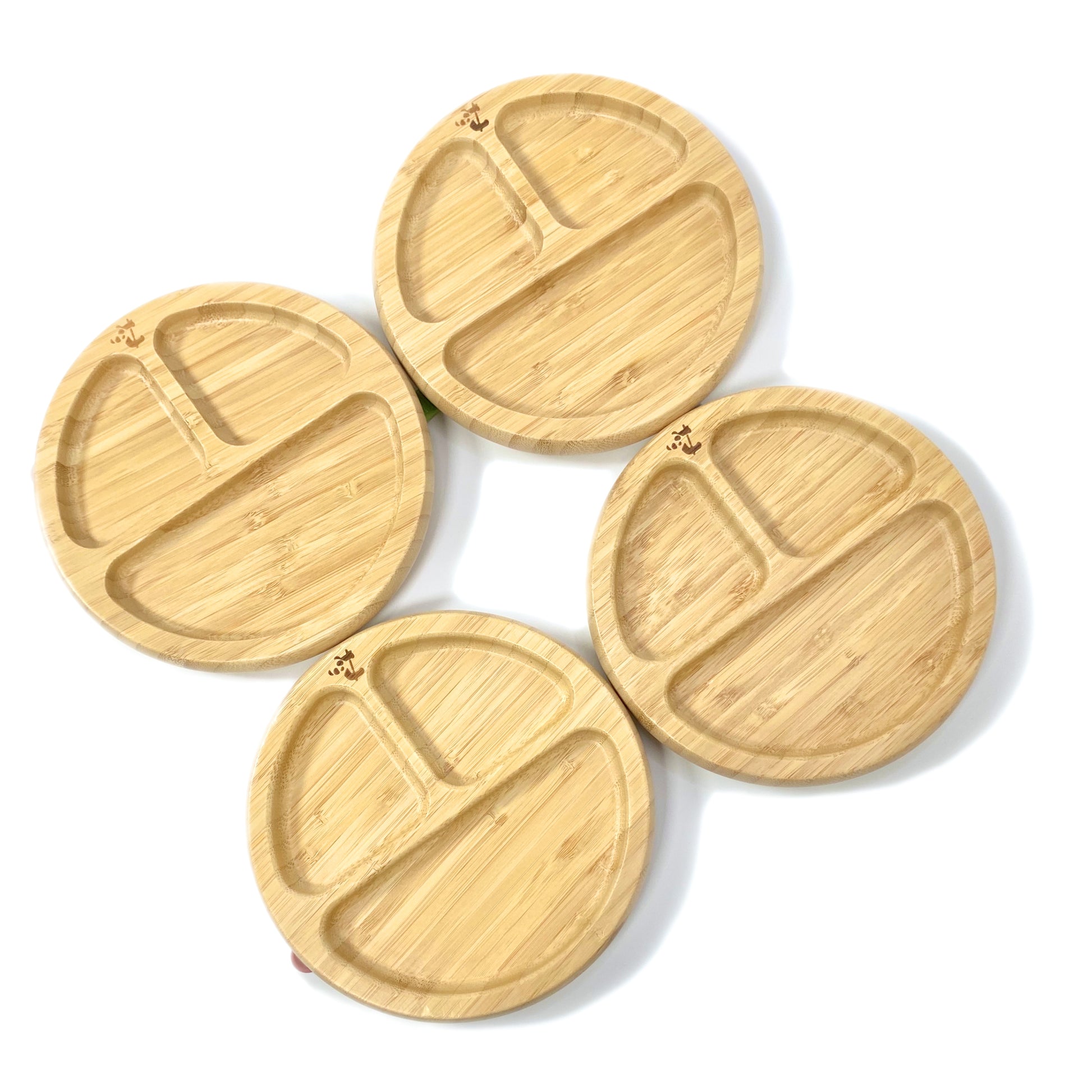 A set of children’s bamboo section plates with colourful silicone suction rings on the base.