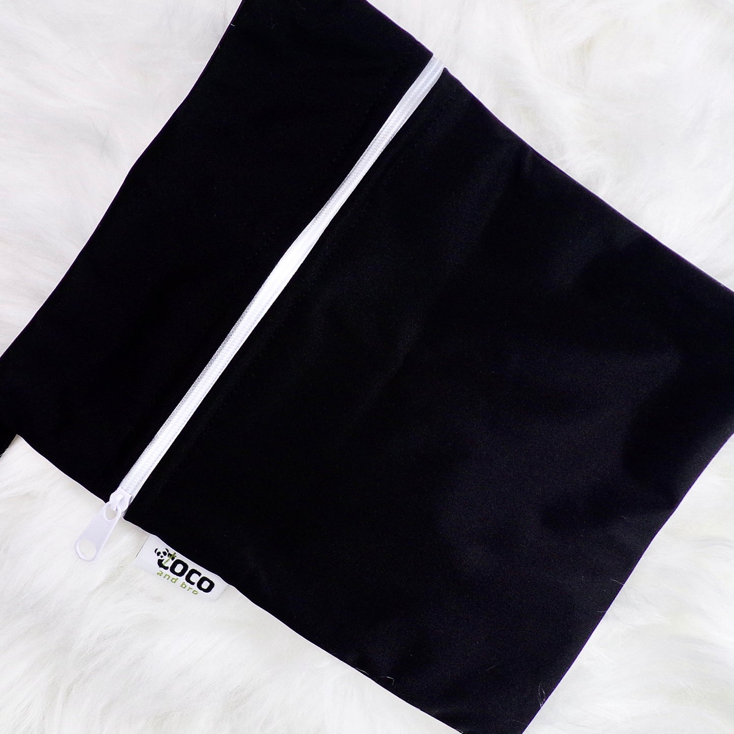 Each backpack purchase includes a free waterproof bag. This image shows the waterproof bag in black, with a zip closure.