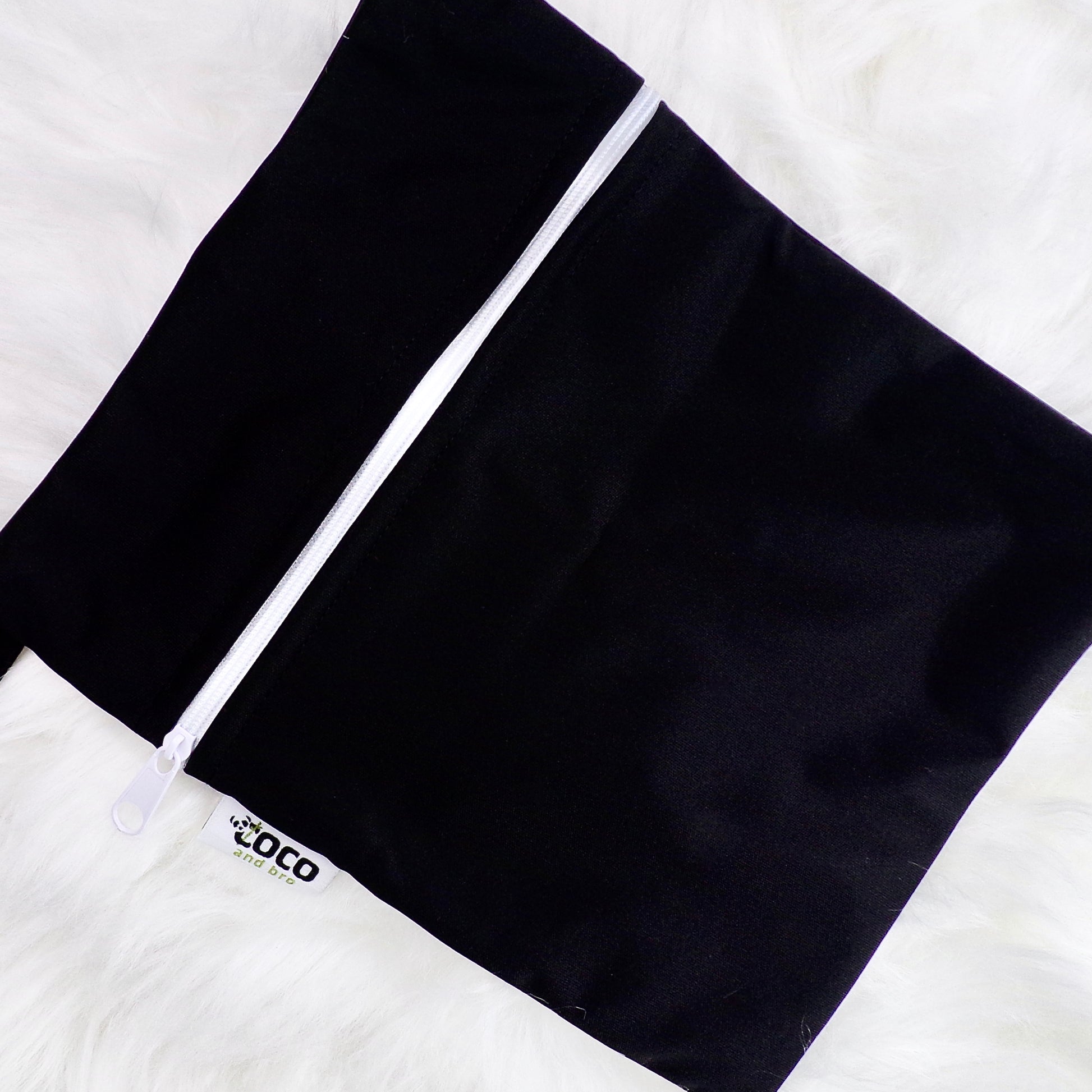 Each backpack purchase includes a free waterproof bag. This image shows the waterproof bag in black, with a zip closure.