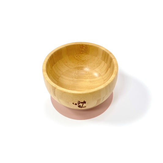 A children’s bamboo bowl with a blossom pink silicone suction ring.