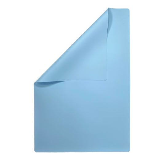 A blue silicone placemat for babies and children, with an embossed Coco and Bro logo in the top right corner.