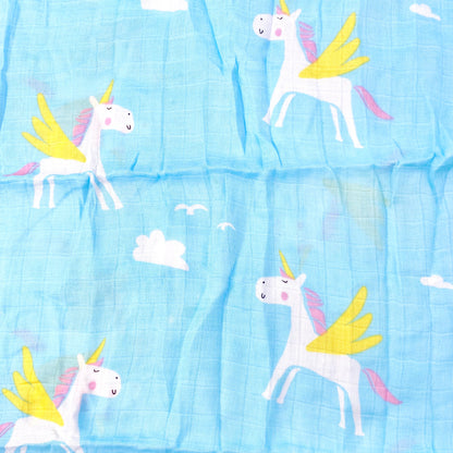 Close up pattern of a blue muslin swaddle blanket with a unicorn design.
