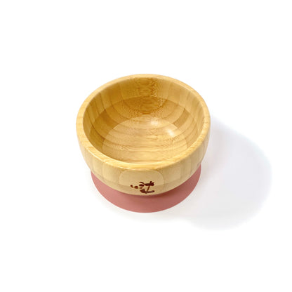 A children’s bamboo bowl with a blush pink silicone suction ring.