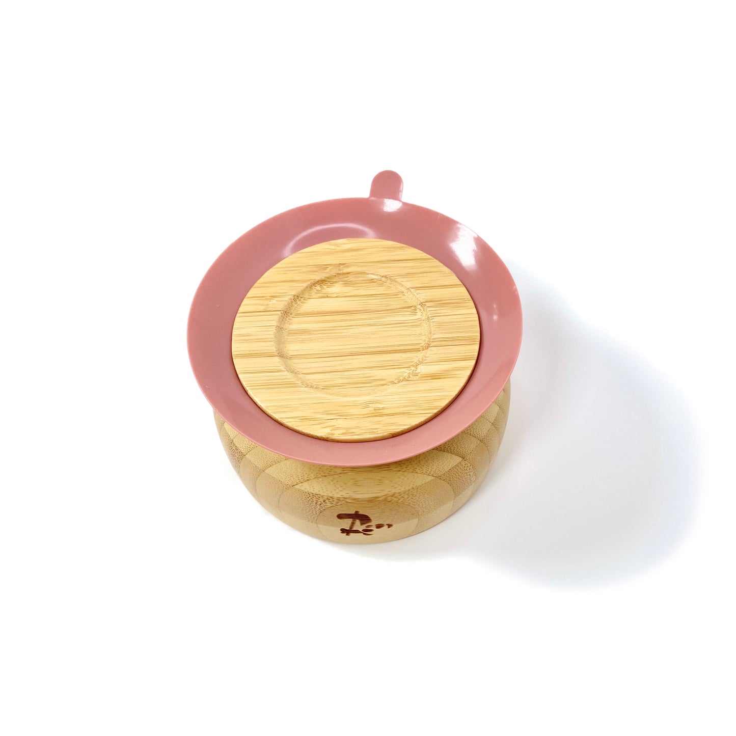 A children’s bamboo bowl with a blush pink silicone suction ring. Image shows the underside of the bowl, featuring the silicone suction ring.