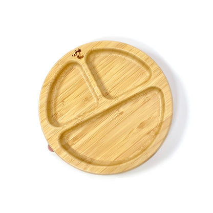 A children’s bamboo section plate with blush pink silicone suction ring on the base.
