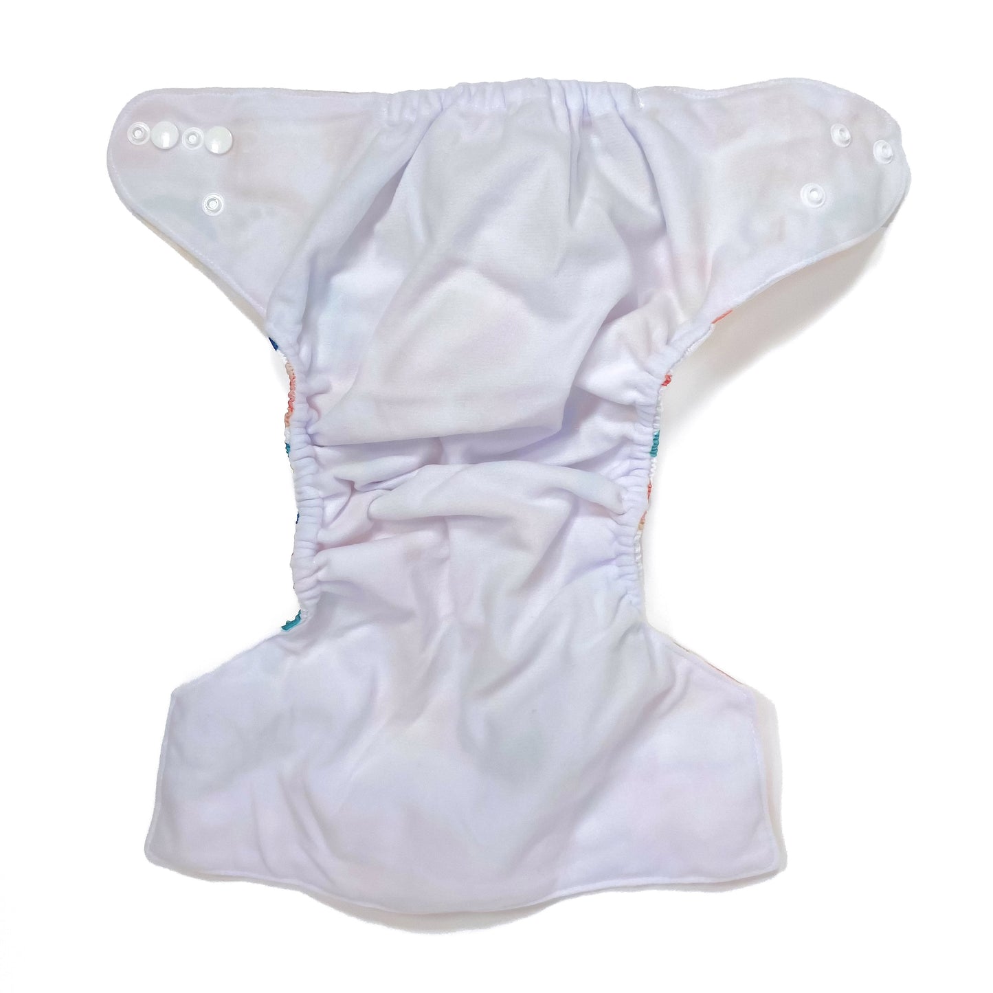 An adjustable reusable nappy for babies and toddlers, featuring a bright rainbow design, with brightly coloured rainbows on a white background. View shows the inside fabric of the nappy.