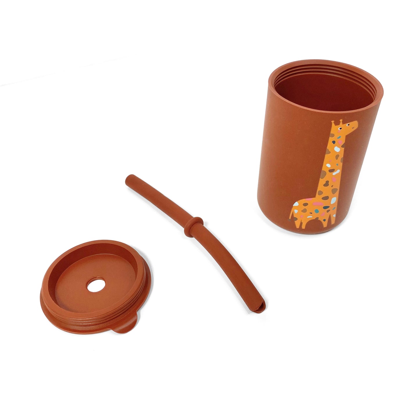 A children’s brown silicone drinking cup, with matching lid and straw, featuring a giraffe design. The image shows the cup, lid and straw separately.