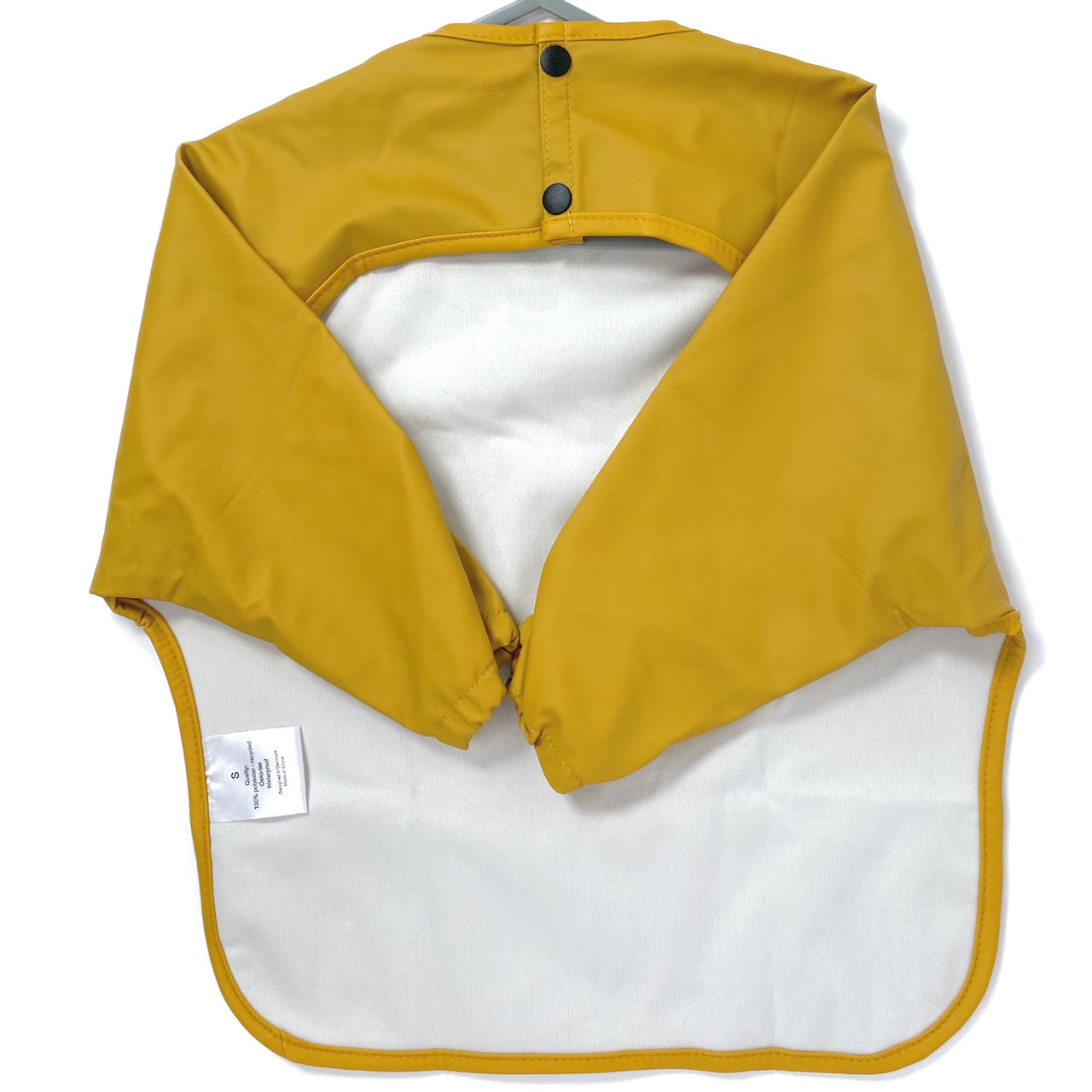 Long-sleeve kids apron in butterscotch yellow colour, showing back view.
