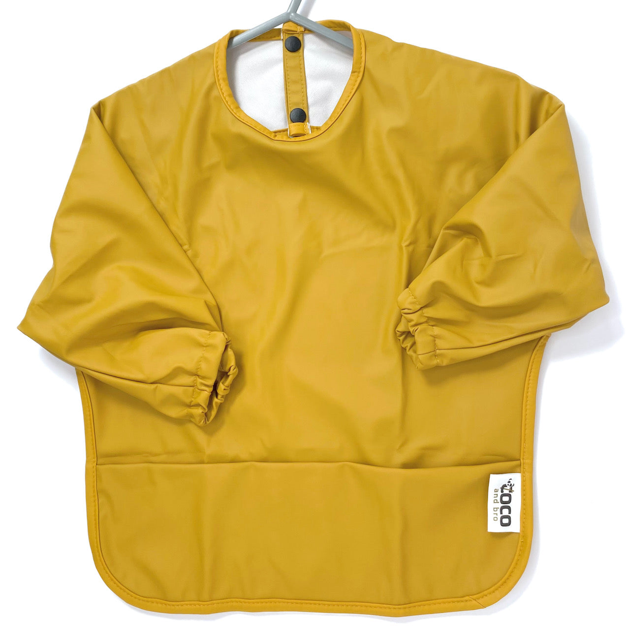 Long-sleeve kids apron in butterscotch yellow colour, showing front view.