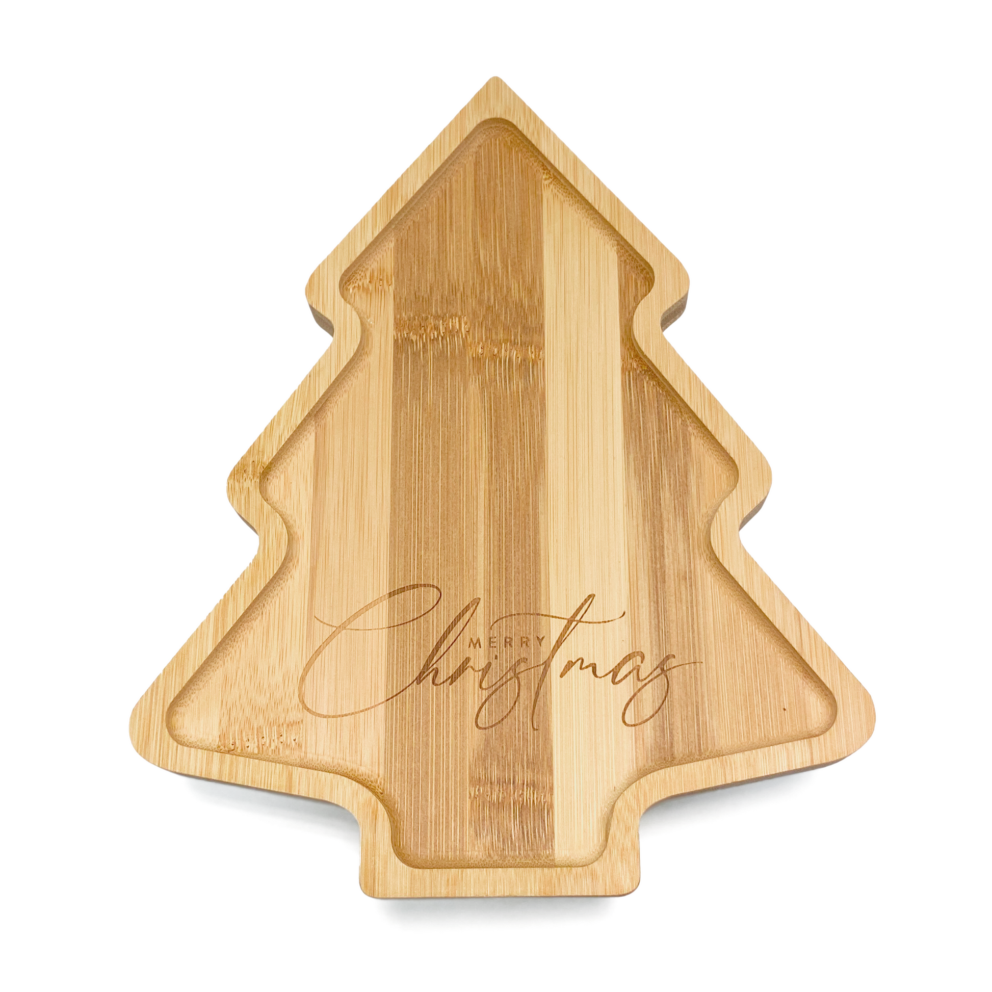A festive children's bamboo plate in the shape of a Christmas tree. The message 'Merry Christmas’ is engraved into the plate. Image shows the front of the plate.