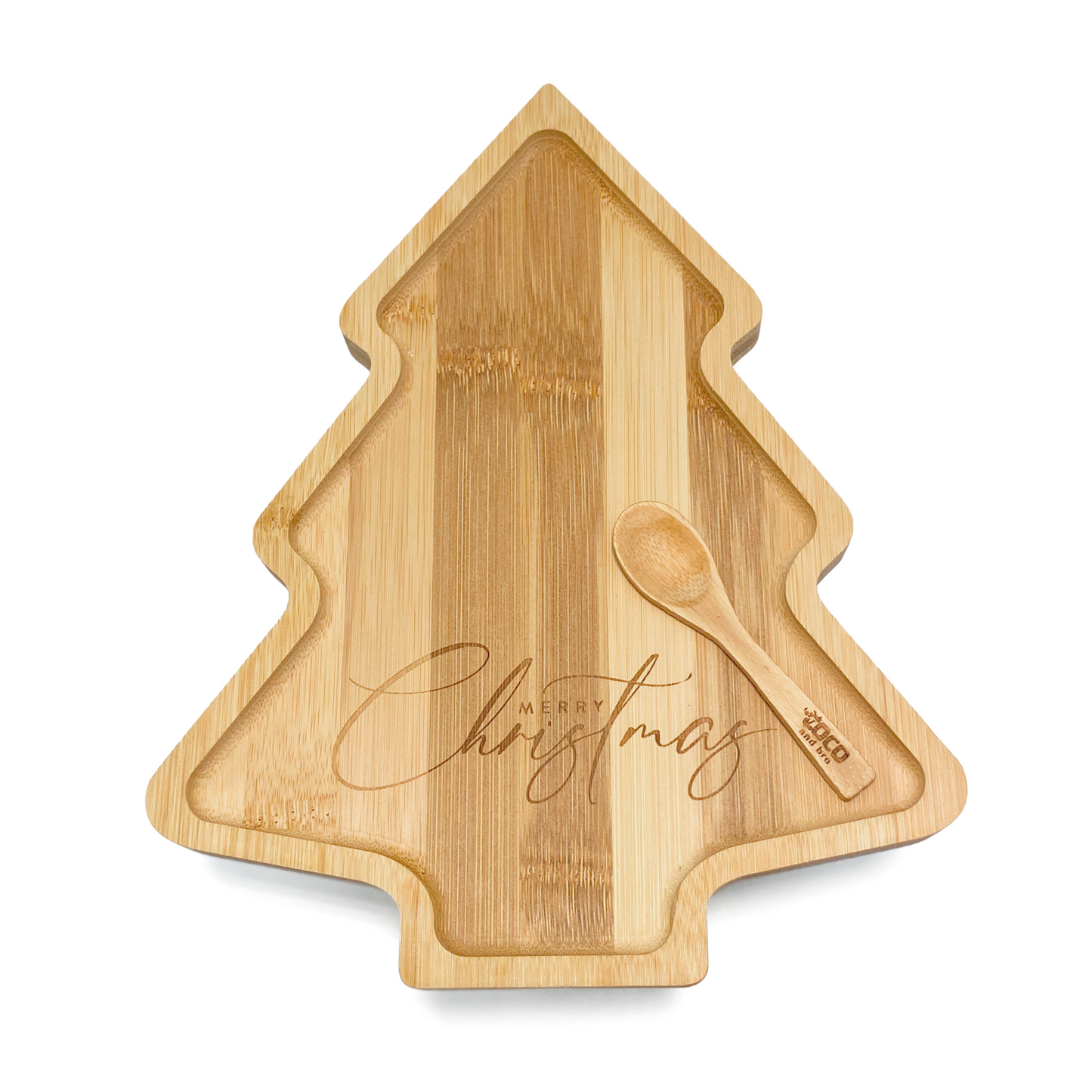 A festive children's bamboo plate in the shape of a Christmas tree. The message 'Merry Christmas’ is engraved into the plate. Image shows the front of the plate, with an engraved wooden spoon.