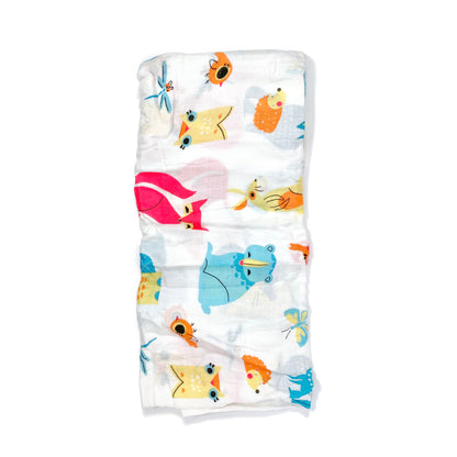 A folded muslin swaddle blanket with a colourful creatures design.