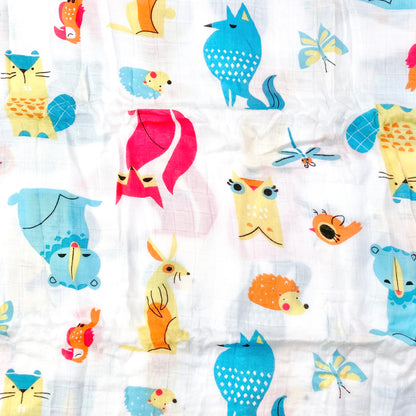 Close up pattern of a muslin swaddle blanket with a colourful creatures design.