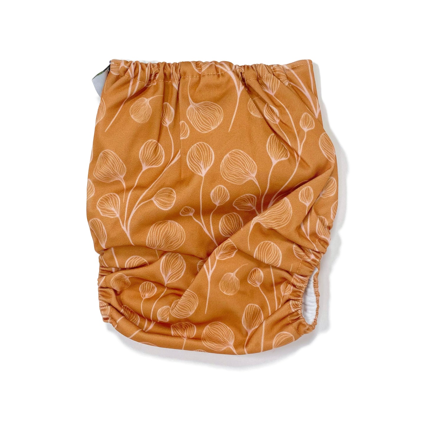 An adjustable reusable nappy for babies and toddlers, featuring a floral copper design, with floral images on a copper background. View shows the back of the nappy.