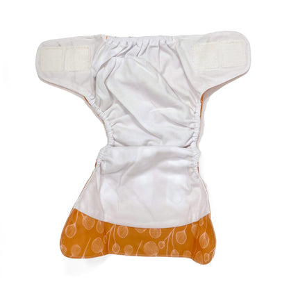An adjustable reusable nappy for babies and toddlers, featuring a floral copper design, with floral images on a copper background. View shows the inside fabric of the nappy.