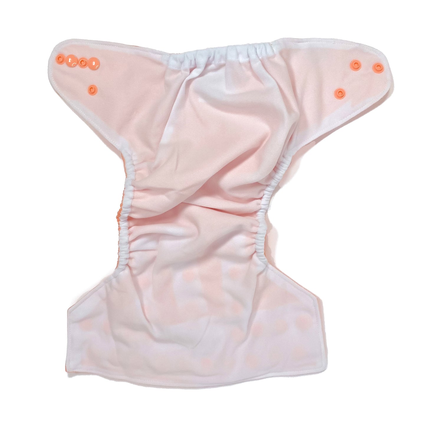 An adjustable reusable nappy for babies and toddlers, in a bright coral colour. View shows the inside fabric of the nappy.