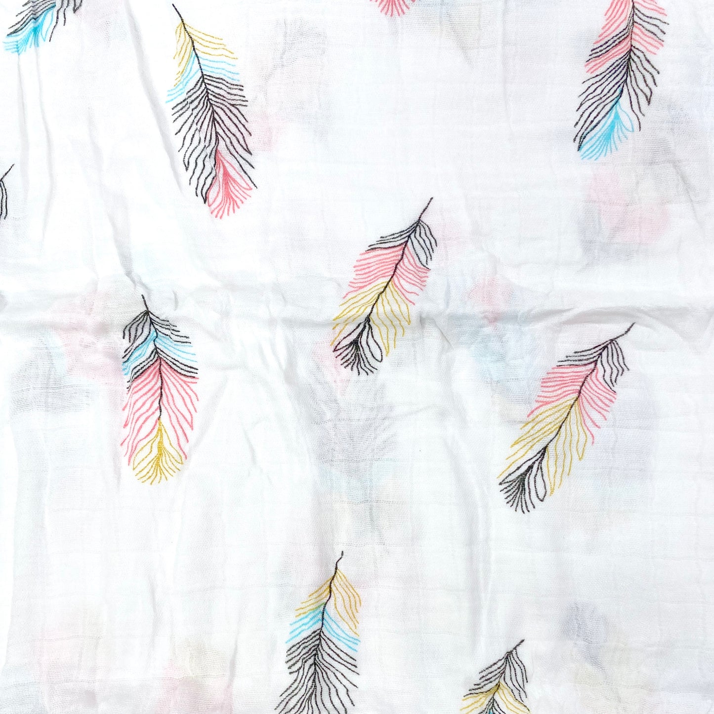 Close up pattern of a muslin swaddle blanket with a feathers design.