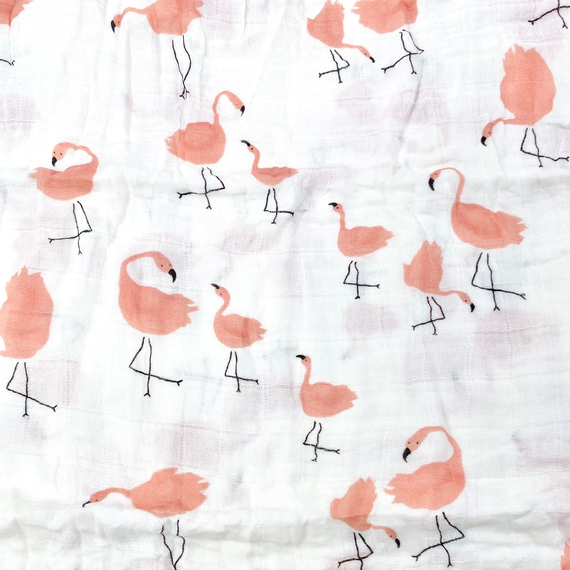 Close up pattern of a muslin swaddle blanket with a flamingo design.