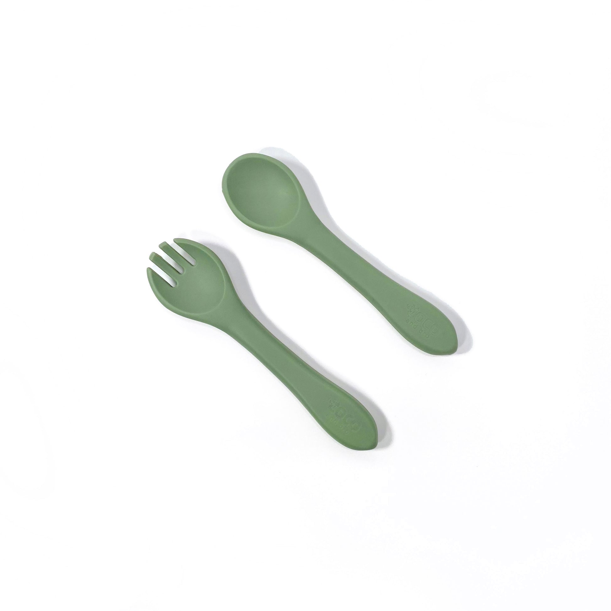 A set of forest green silicone children’s cutlery.