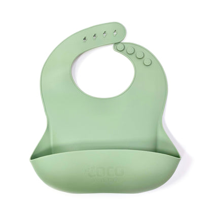 An adjustable forest green silicone children’s bib with crumb catcher pocket.