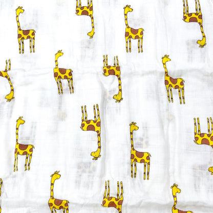 Close up pattern of a muslin swaddle blanket with a giraffe design.