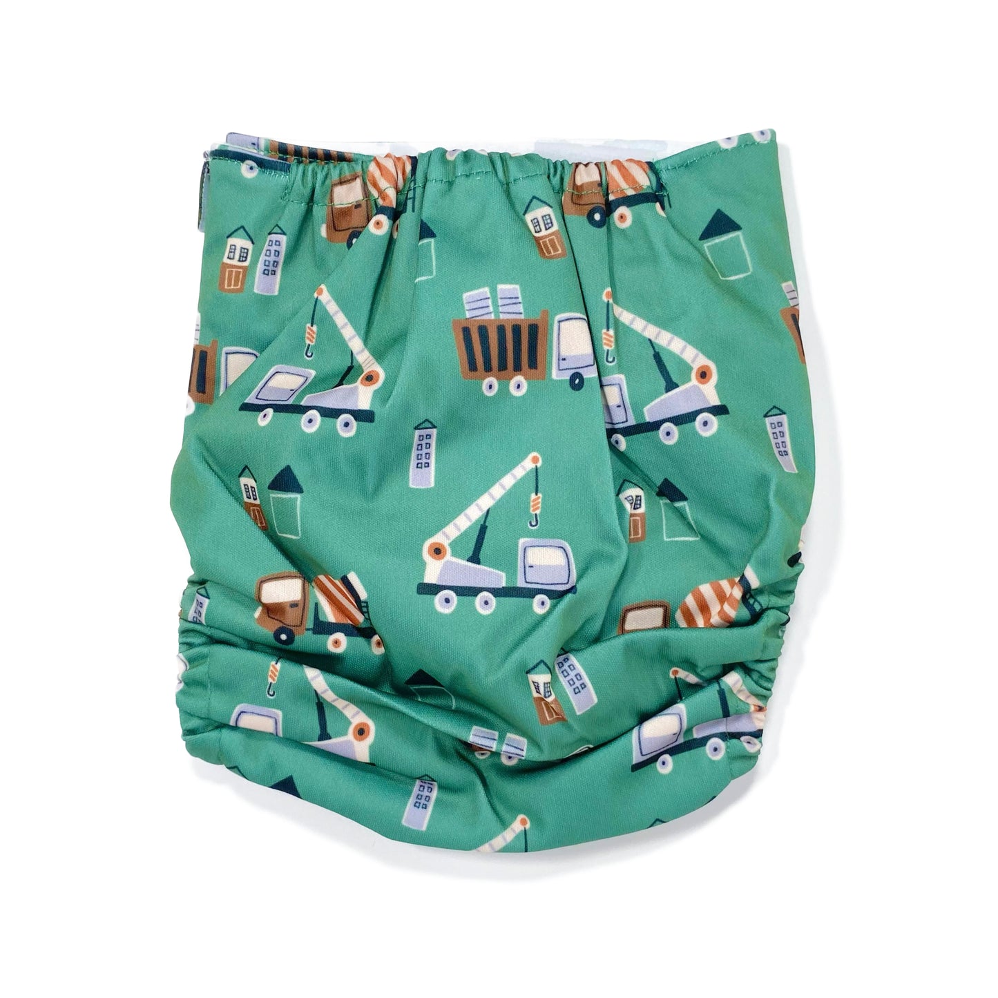 An adjustable reusable nappy for babies and toddlers, featuring a green construction design, with images of construction vehicles on a green background. View shows the back of the nappy.