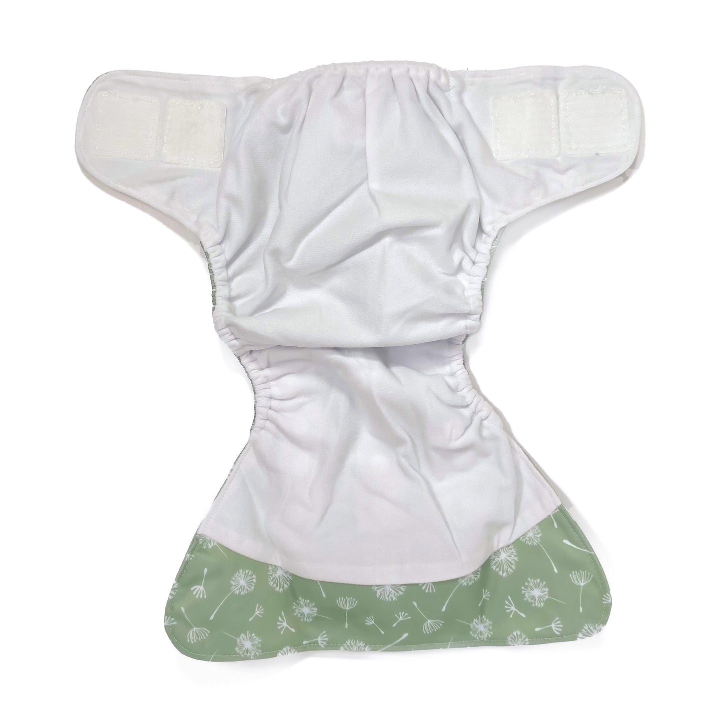 An adjustable reusable nappy for babies and toddlers, featuring a green dandelion design, with images of dandelion seeds on a green background. View shows the inside fabric of the nappy.