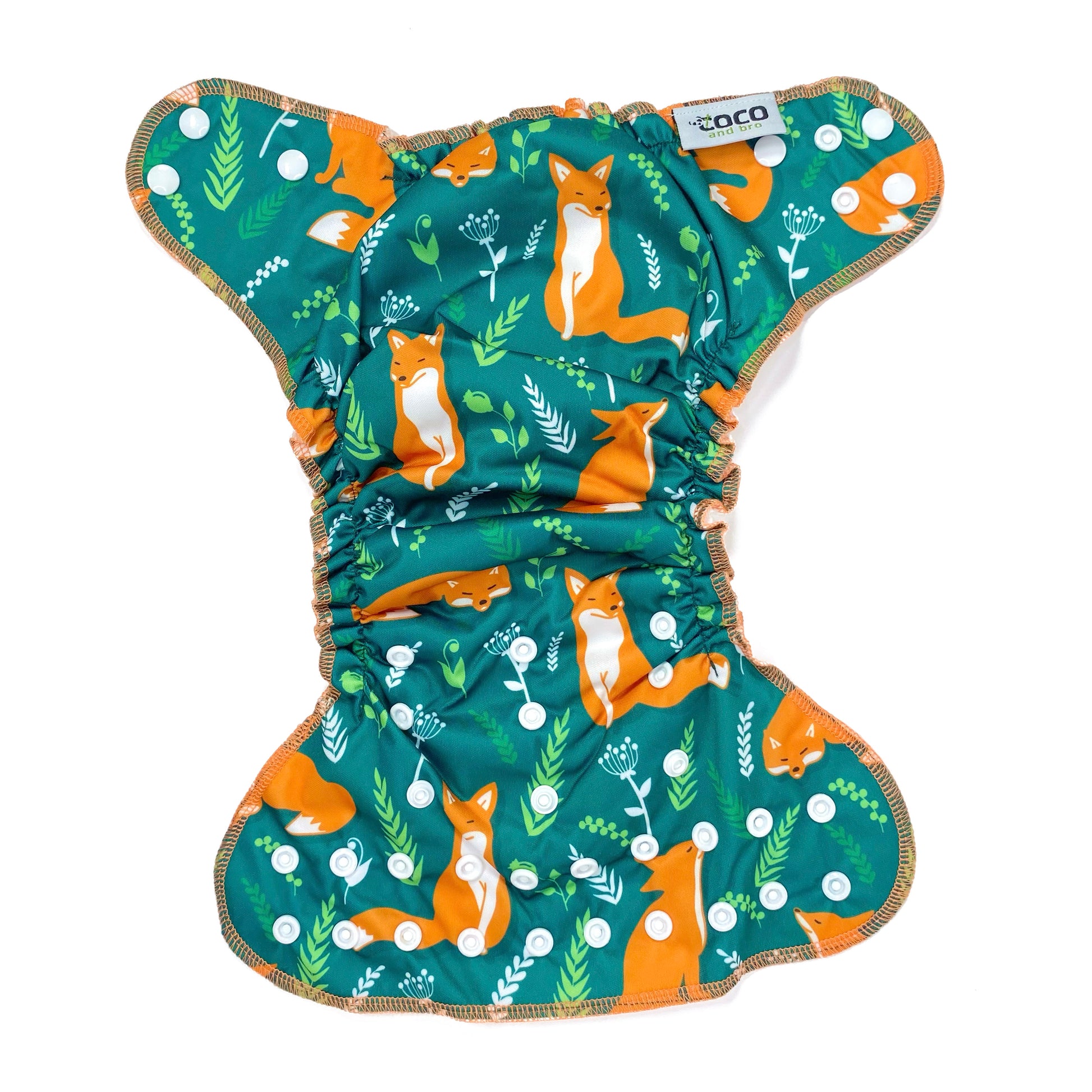 An adjustable reusable nappy for babies and toddlers, featuring a green fox design, with images of foxes on a green background. View shows the full outside pattern of the nappy, with fastenings open.