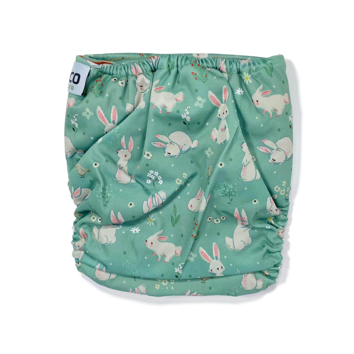 An adjustable reusable nappy for babies and toddlers, featuring a green rabbits design, with images of grey rabbits on a green background. View shows the back of the nappy.