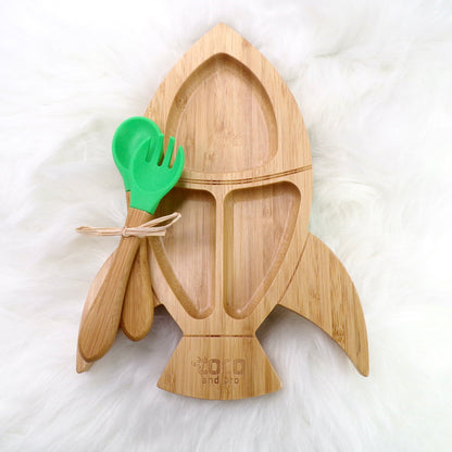 A children's bamboo section plate with a rocket design, green colour silicone suction ring and matching green bamboo and silicone cutlery. Front view.