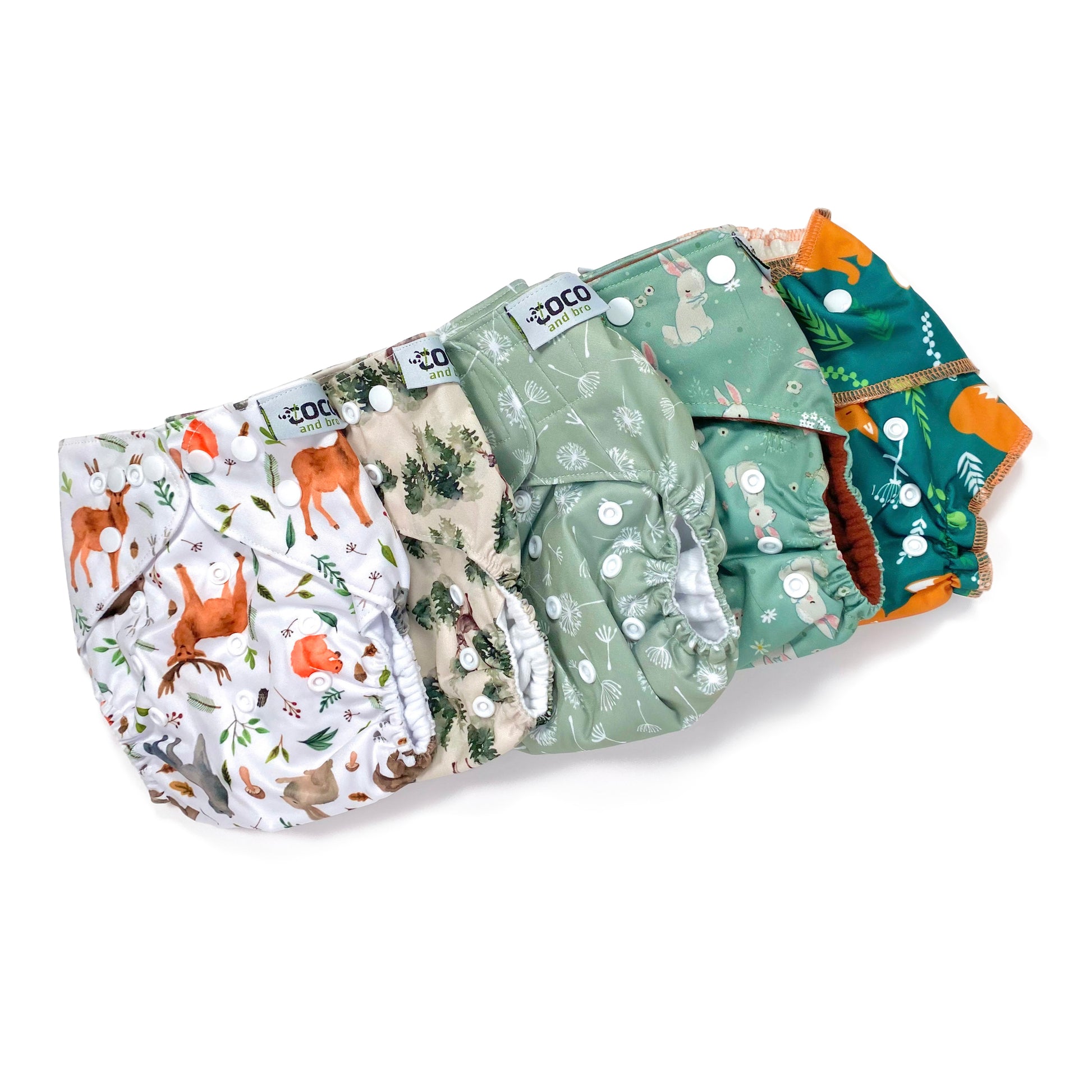 A set of five reusable nappies, made from 100% recycled polyester. The included nappies are: Woodland Friends, Winter Forest, Green Dandelion, Green Rabbits and Green Fox. View shows all five nappies front facing, in a diagonal line.
