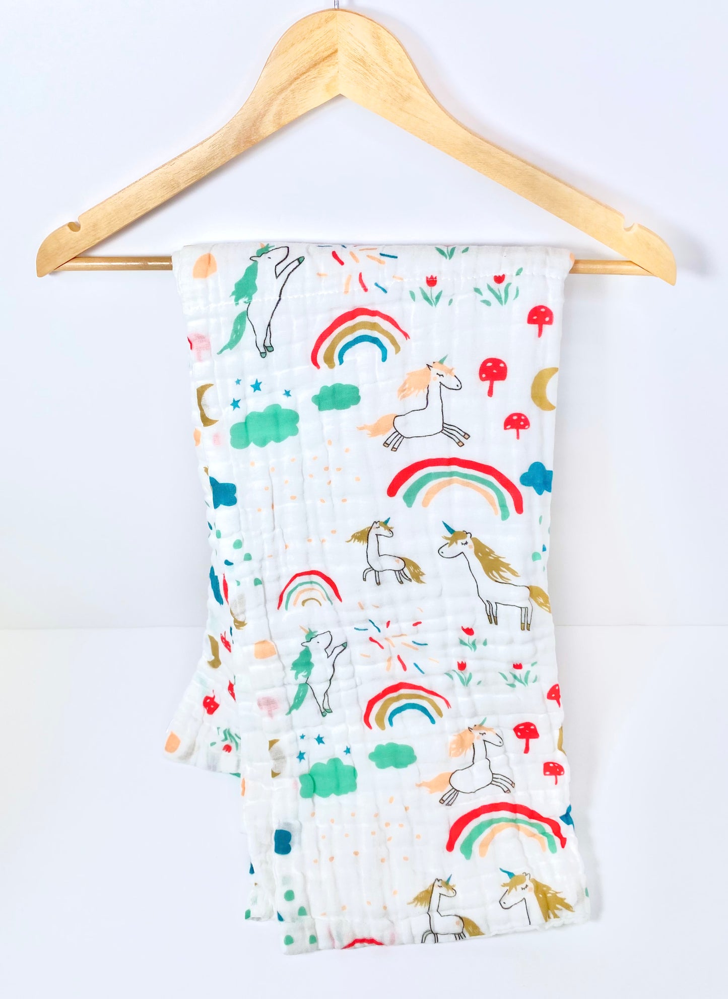 A large muslin baby blanket, made from bamboo and cotton fibres. This blanket is perfect for a baby nursery or out and about in a buggy. The blanket features a cute unicorn pattern.