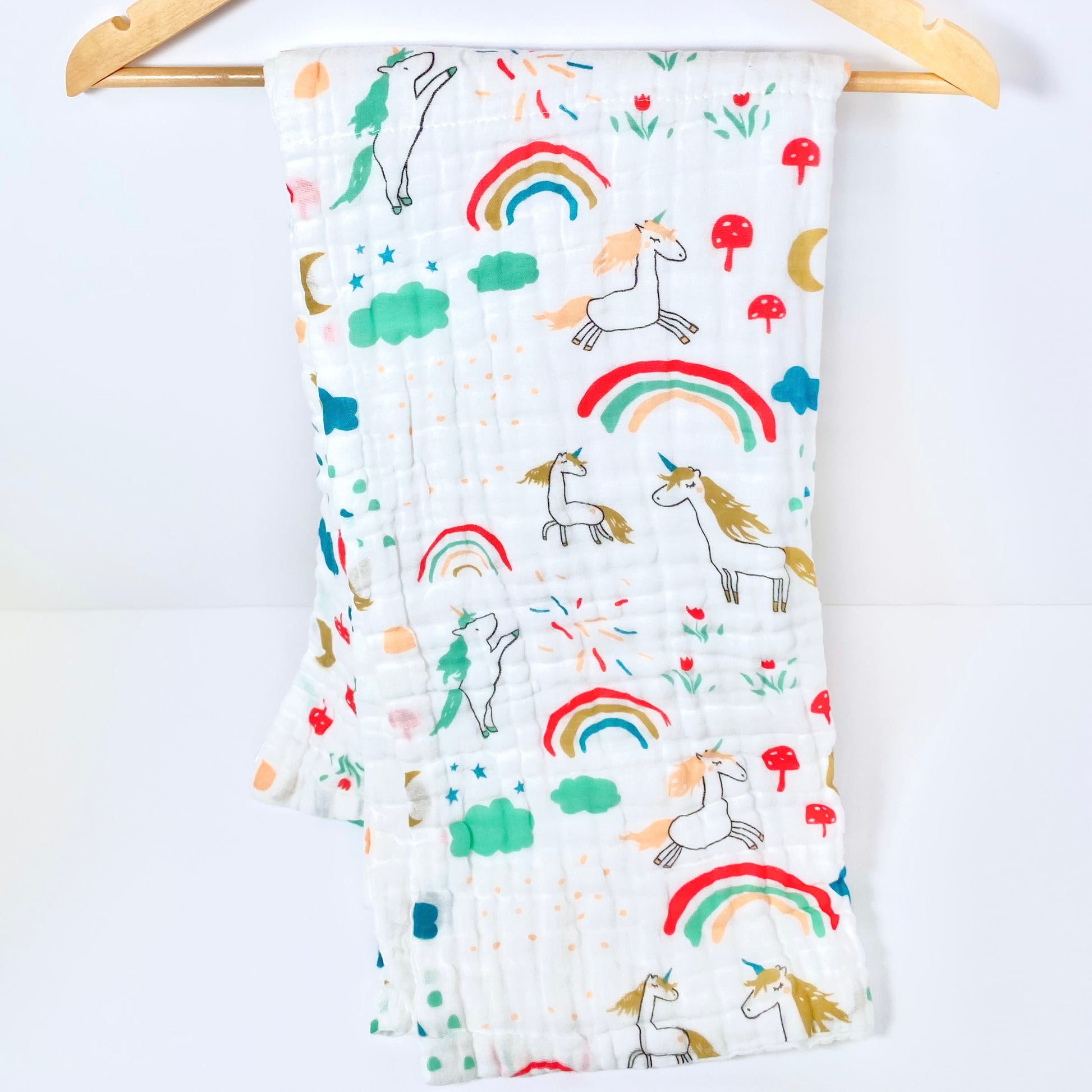 A large muslin baby blanket, made from bamboo and cotton fibres. This blanket is perfect for a baby nursery or out and about in a buggy. The blanket features a cute unicorn pattern.