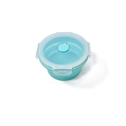 A collapsible blue circular silicone food storage tub with lid. View from the side, tub has been fully expanded and has the lid attached.