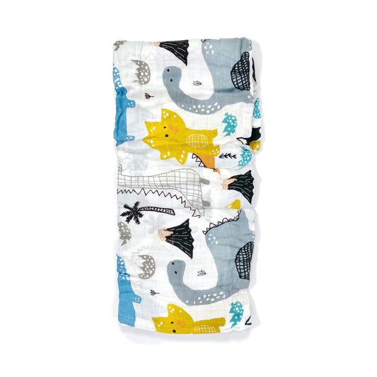 A folded muslin swaddle blanket with a dinosaur doodle design.