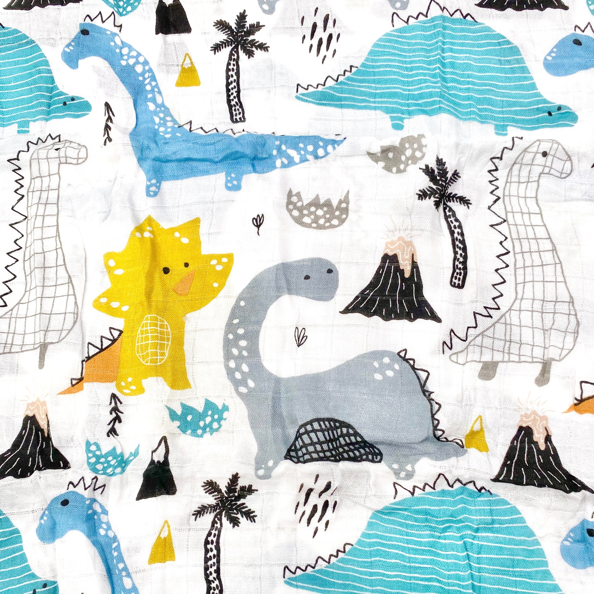 Close up pattern of a muslin swaddle blanket with a dinosaur doodle design.